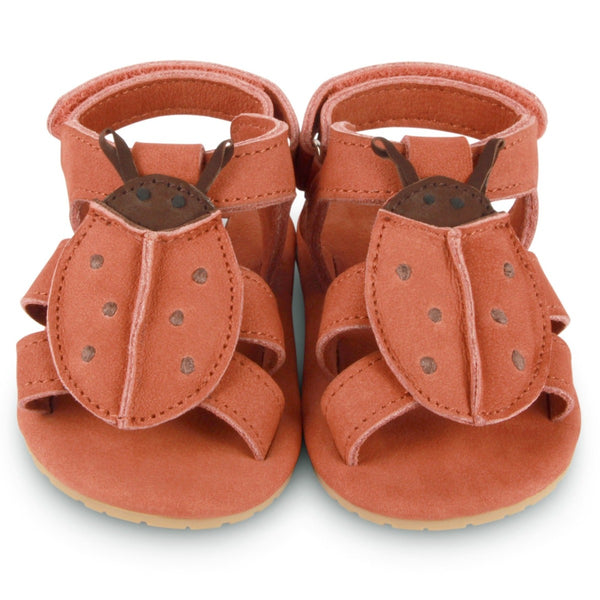 US stockist of Donsje USA's Lady Bird Tuti Sky  premium handmade leather sandals.  Red in color with beautiful lady bird on front and velcro fastening at back.  Sizes 0-12 mths have soft sole, 12-30mths have a soft flexible, rubber sole.