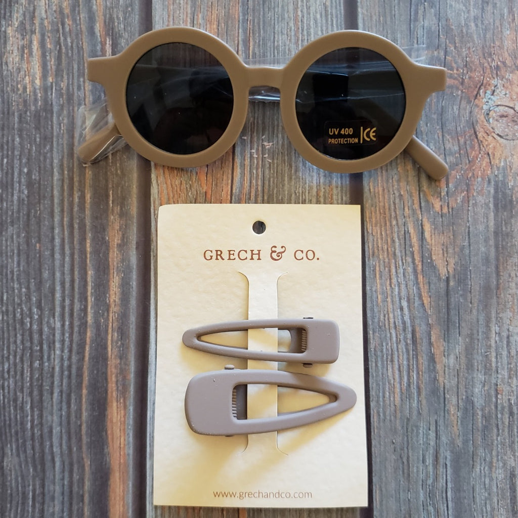 US stockist of Grech & Co's gender neutral sustainable sunglasses.  Made from recycled plastic, with round grey lens with UV 400 protection in a stone grey color.
