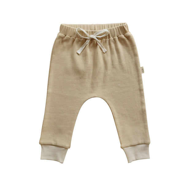 US stockist of India + Grace The Label's relaxed fit, gender neutral ribbed cotton leggings in beige.  Features contrasting cream cuffs and non functional drawstring at waist.