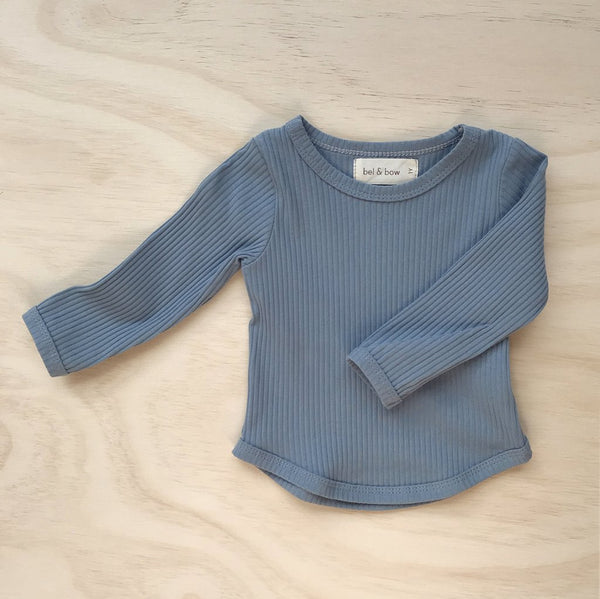 US stockist of Bel & Bow's dusty blue long sleeve ribbed cotton top with curved hem.