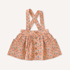 US stockist of Lacey Lane's Peach suspender skirt.  Peach cotton fabric with a pretty design of white and blue flowers.  Features pockets and oversized buttons down front.