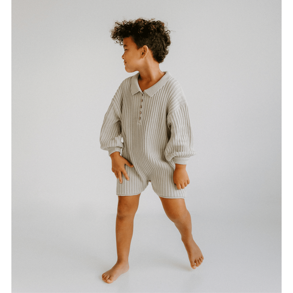 US stockist of Illoura the Label's gender neutral, Essential Knit Romper in Powder Blue.  Made from 100% rib cotton with coconut buttons on placket and a collar.