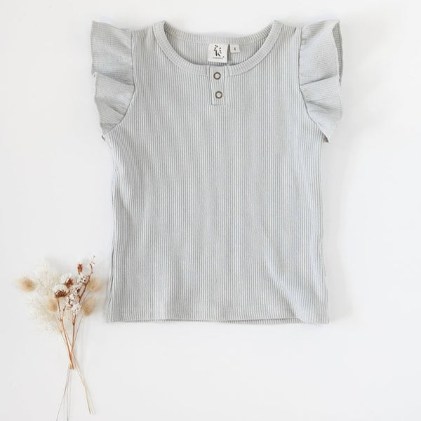 US stockist of Karibou Kids Keira Flutter Sleeve Waffle top in sky; a dusty light blue.  Made from a soft cotton and spandex blend.