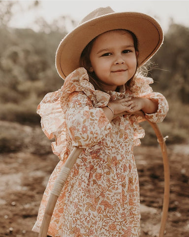 US stockist of Bonnie & Harlo's long sleeve floral dress in hues of pink and peach.  Fully lined, with hidden zip at the back and ruffle detailing.