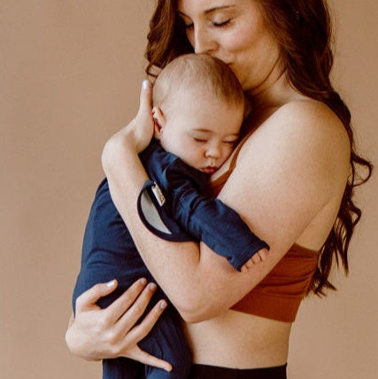 Stockist of Bonsie's rayon blend midnight blue footie.  Top section has velcro wrap body which can be undone for skin to skin contact.  Elastic waist that can be pulled down for easy diaper changes. 