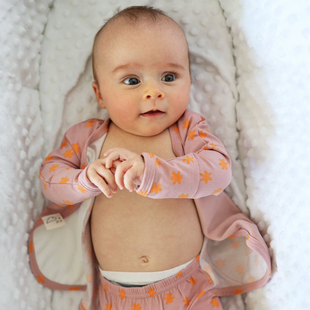 Stockist of Bonsie Babywear's Footed   muted pink kimono style romper featuring a print of stars