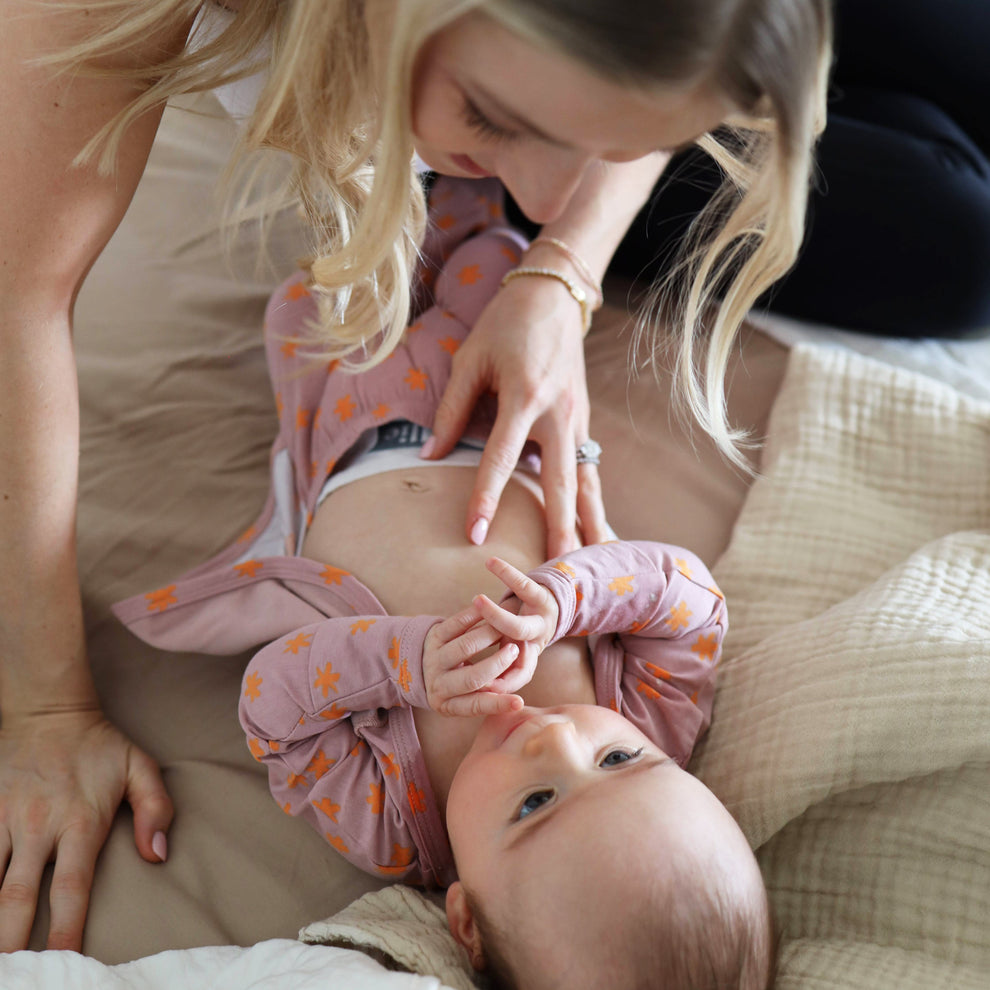 Stockist of Bonsie Babywear's Footed   muted pink kimono style romper featuring a print of stars