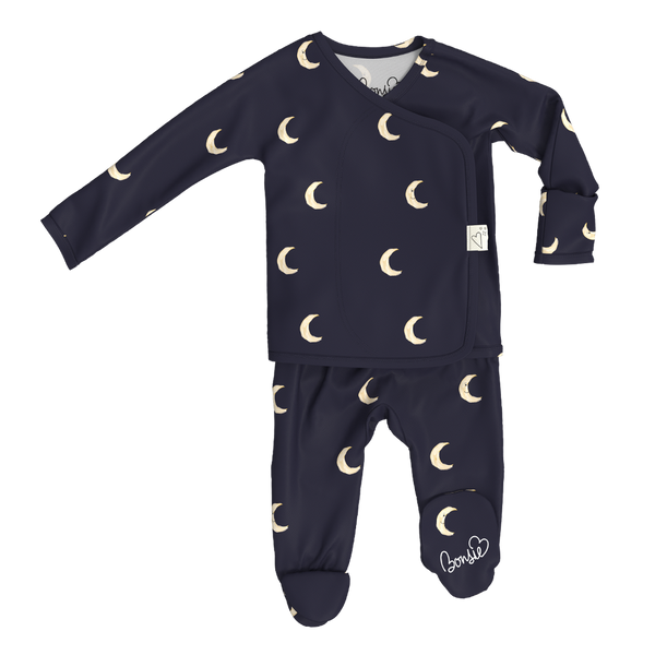 Stockist of Bonsie Babywear's Footed, dark blue "Gnight Moon" kimono style romper featuring a crescent moon print