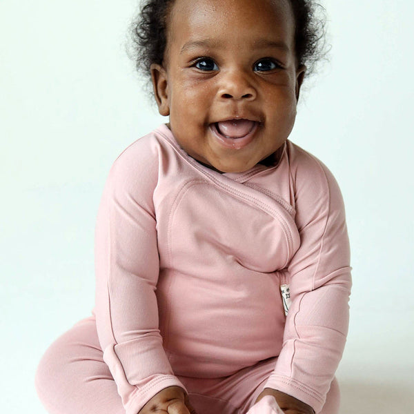 Stockist of Bonsie's rayon blend Peony pink footie.  Top section has velcro wrap body which can be undone for skin to skin contact.  Elastic waist that can be pulled down for easy diaper changes. 