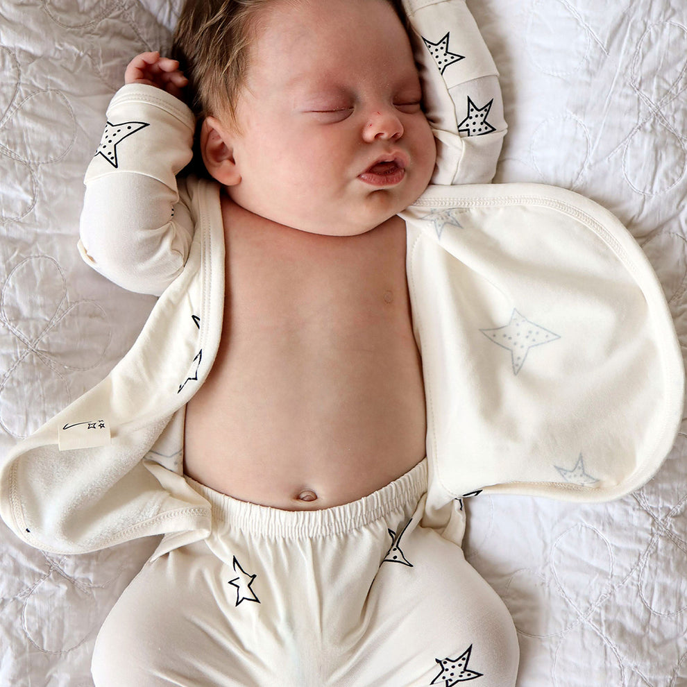 Stockist of Bonsie's rayon blend star print footie.  Top section has velcro wrap body which can be undone for skin to skin contact.  Elastic waist that can be pulled down for easy diaper changes. 