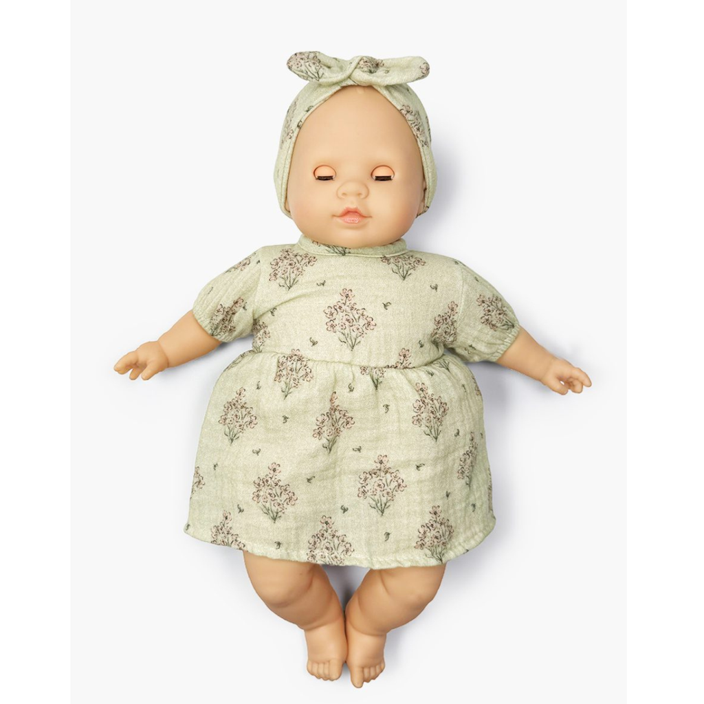 US stockist of Minikane's Emilie Sleepy doll dressed in a Faustine dress with matching headband 