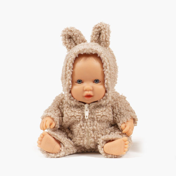 US stockist of Minikane's Greta Peque doll dressed in a beige Winnie the Pooh jumpsuit.