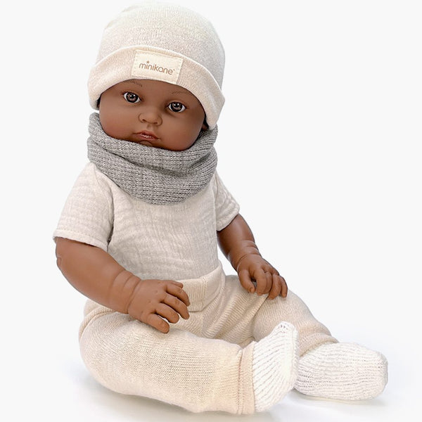US stockist of Minikane's Augustin Bambini Boy doll dressed in his Beige Winter outfit.