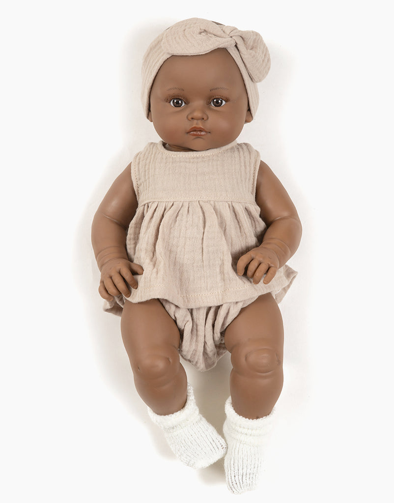 US stockist of Minikane's Augustine Bambini girl doll in her Beige cotton gauze set with matching headband