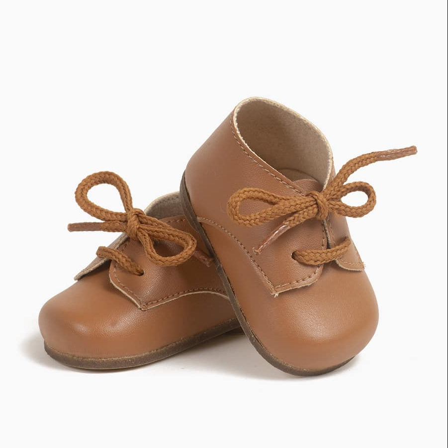 US stockist of Minikane's gender neutral lace up Derby shoes in Caramel.  For Bambini dolls.