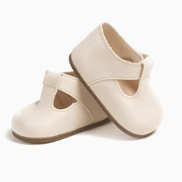 US stockist of Minikane's Cream t-strap shoes for Bambini dolls.