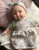 US stockist of Minikane's Emilie Sleepy doll dressed in a Faustine dress with matching headband 