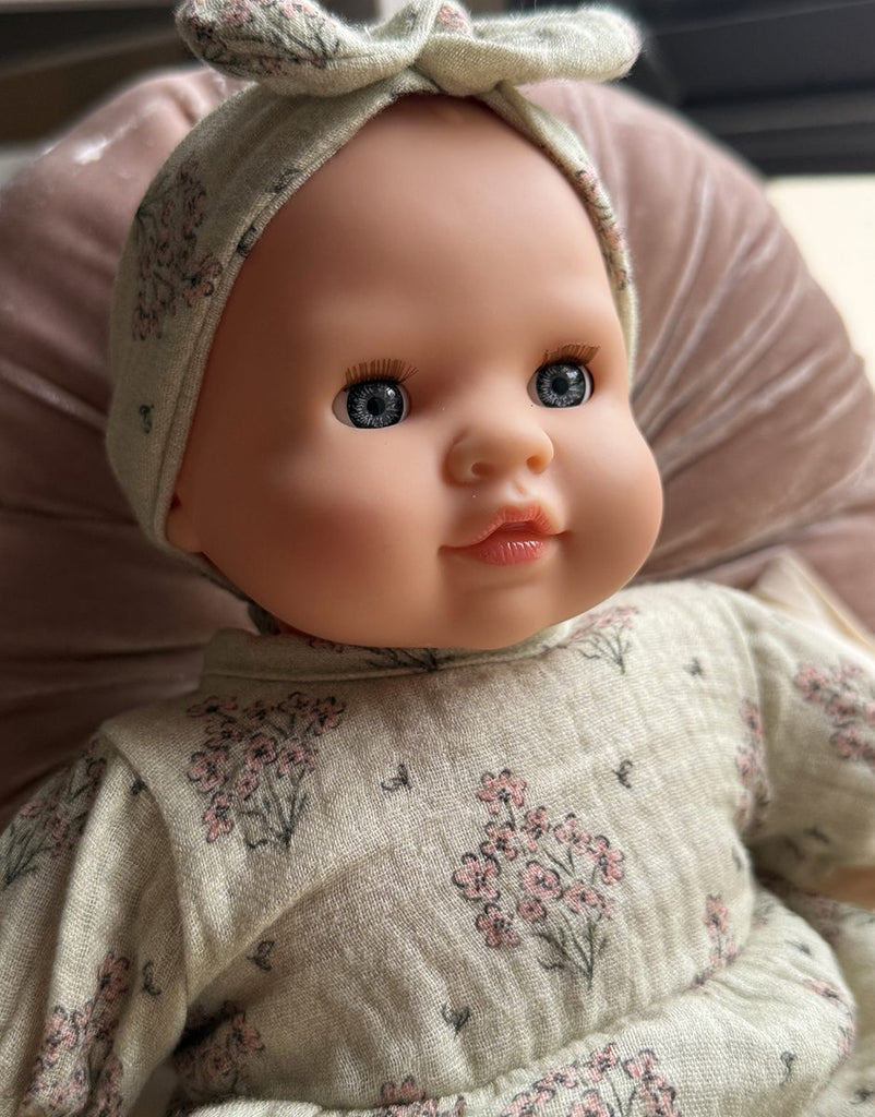 US stockist of Minikane's Emilie Sleepy doll dressed in a Faustine dress with matching headband 