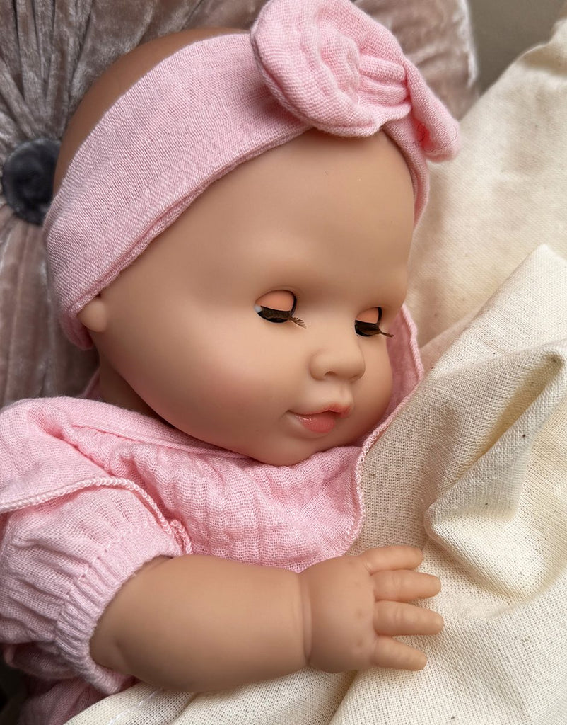 US stockist of Minikane's Emilie Sleepy doll dressed in an Eva romper with matching headband 