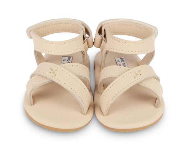 US stockist of Donsje USA's Giggles premium handmade leather sandals.  Cream in color with velcro fastening at back.  Sizes 0-12 mths have soft sole, 12-30mths have a soft flexible, rubber sole.