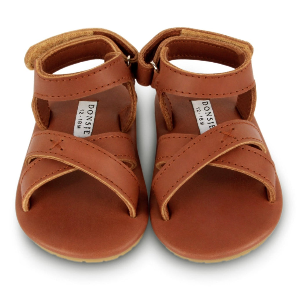 US stockist of Donsje USA's Giggles premium handmade leather sandals.  Classic cognac in color with velcro fastening at back.  Sizes 0-12 mths have soft sole, 12-30mths have a soft flexible, rubber sole.