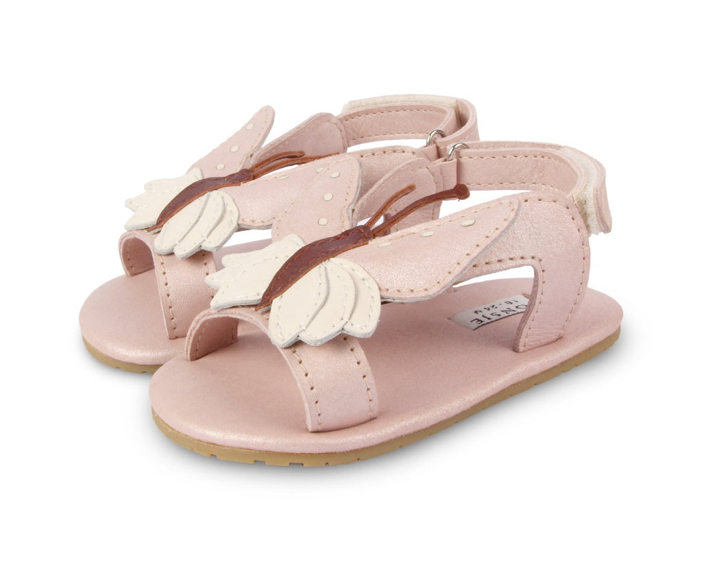 US stockist of Donsje USA's Butterfly Tuti Sky  premium handmade leather sandals.  Pink in color with beautiful cream/pink butterfly on front and velcro fastening at back.  Sizes 0-12 mths have soft sole, 12-30mths have a soft flexible, rubber sole.