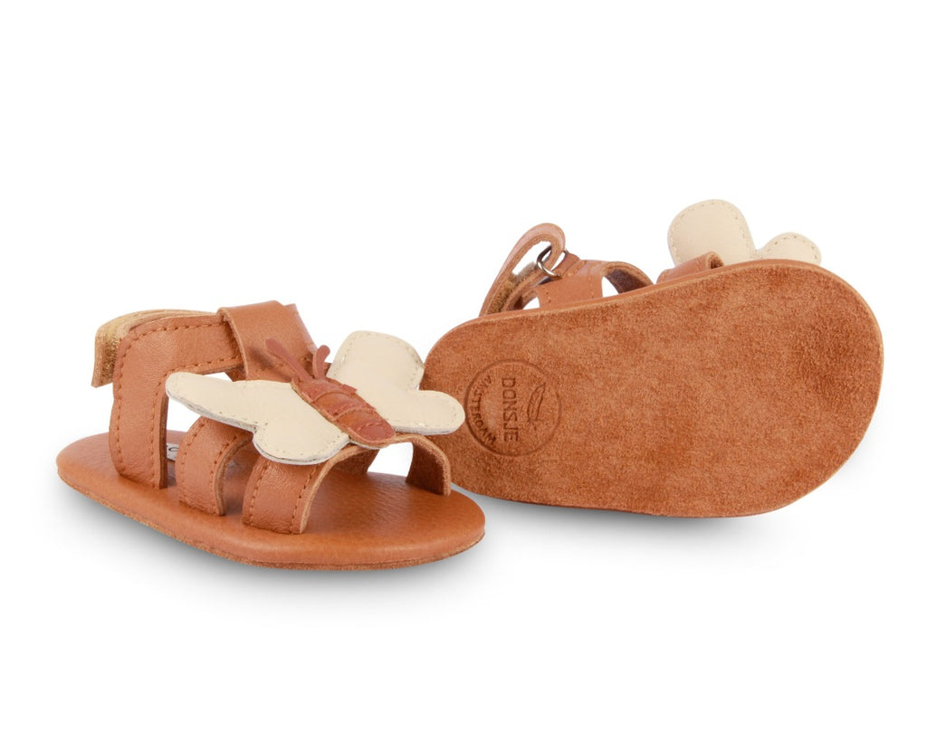 US stockist of Donsje USA's Honey Bee Tuti Sky  premium handmade leather sandals.  Tan in color with beautiful tan/cream honey bee on front and velcro fastening at back.  Sizes 0-12 mths have soft sole, 12-30mths have a soft flexible, rubber sole.