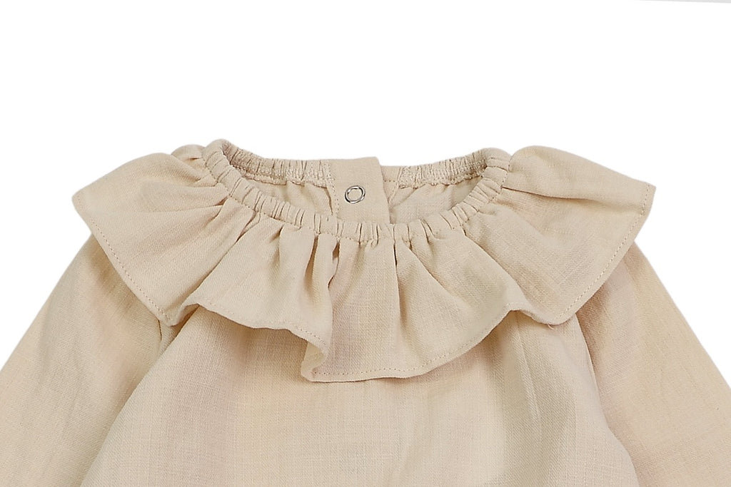 US stockist of Donsje's long sleeve chloe bodysuit in Buttercream.  Made from cotton with a ruffle neck.