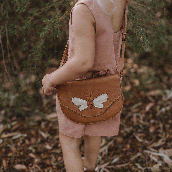 US stockist of Donsje's Honey Bee  Huna Purse.  Handmade from tan leather with a tan/cream honey bee on front and an adjustable strap.