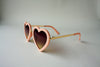 US stockist of Elle Porte's Heart shaped sunglasses in peach.