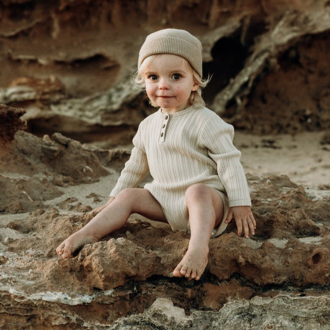 US stockist of Grown Clothing's gender neutral, organic cotton ribbed button bodysuit in Natural.