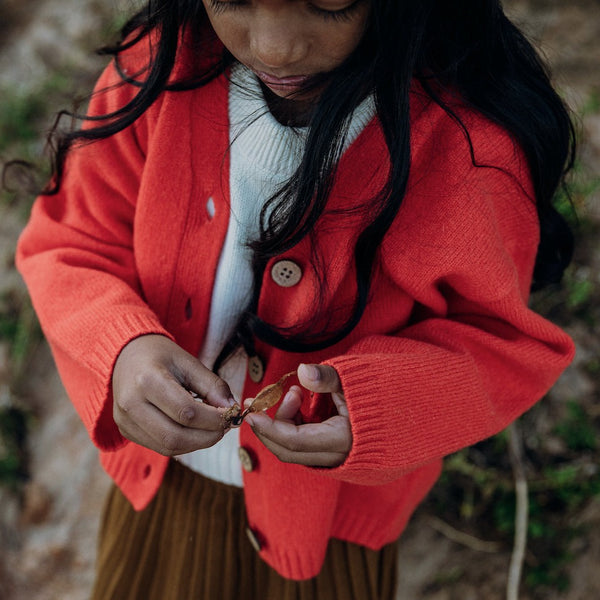 US stockist of Grown Clothing's gender neutral, merino wool cardigan in Tangerine.