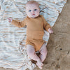 US stockist of Grown Clothing's gender neutral, organic cotton ribbed essential bodysuit in Buttermilk.