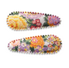 US stockist of Josie Joan's Audrey fabric hair clips.  Set of two fabric hair clips made from pale coloured fabric with bright orange, purple, red, yellow or pink flowers and  contrasting green leaves.  Has scalloped edging.
