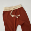 US stockist of Bel & Bow's gender neutral ribbed cotton joggers in rust.  Has a contrasing cream cuffs and waistband with functional drawstring.