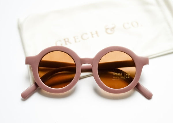 US stockist of Grech & Co's gender neutral sustainable sunglasses.  Made from recycled plastic, with round amber lens with UV 400 protection in a burlwood color.