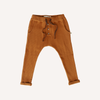 US stockist of My Brother John's Cinnamon long john pants. Made in warm earth tone fabric with cozy fleecy lining, skinny leg, drop crotch, pockets, functional drawstring at waist and decorative buttons down the front.