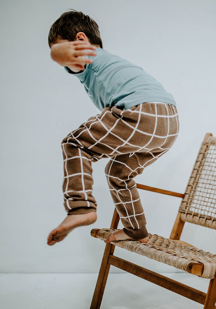 US stockist of Miann & Co's baby knit pants in cafe au lait grid. Made from 100% cotton with elastic waist, functional drawstring and pockets.