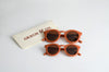 US stockist of Grech & Co's kids polarized sustainable sunglasses in rust.