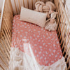 US stockist of Snuggle Hunny Kid's Daisy stretch cotton jersey crib sheet. Dusky pink color with white daisy print.