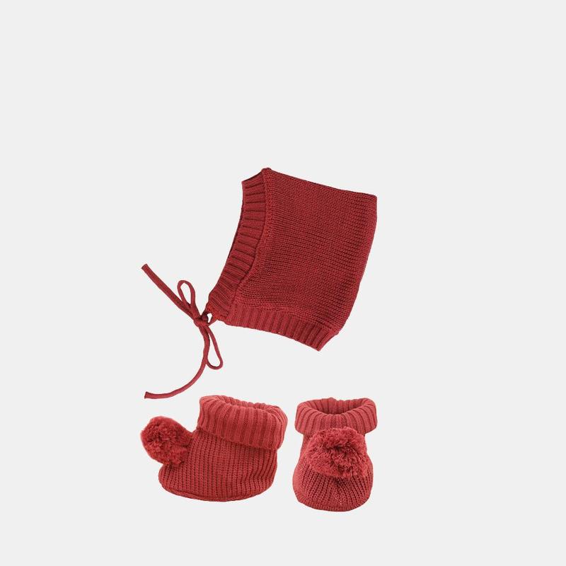 US stockist of Olli Ella's Dinkum Doll Knit Berry Set.  Features cotton knit bonnet and hard sole knit booties with pom poms on front. 