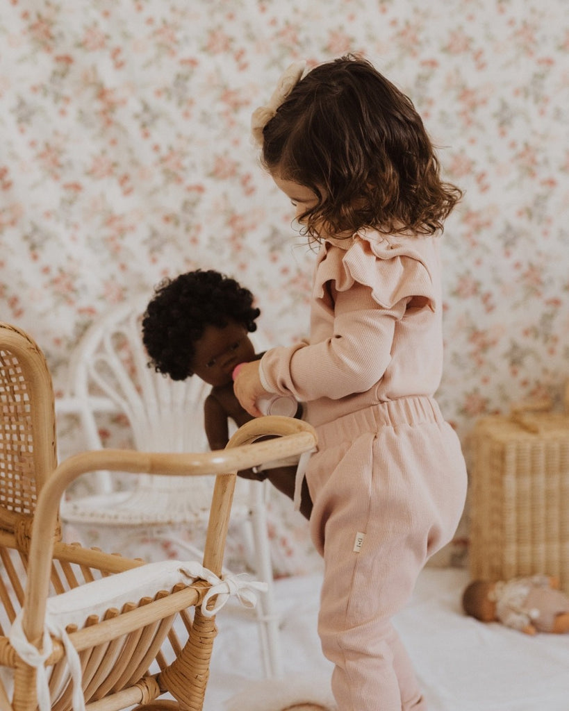 US stockist of India + Grace The Label's dusty pink long sleeved ribbed cotton bodysuit.  Features crotch snaps and beautiful ruffles at shoulder.  