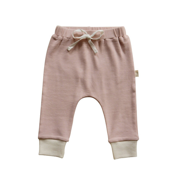 US stockist of India + Grace The Label's relaxed fit ribbed cotton leggings in dusty pink.  Features contrasting cream cuffs and non functional drawstring at waist.