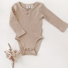 US stockist of Karibou Kids gender neutral, fawn Willow long sleeve henley bodysuit in ribbed cotton blend.