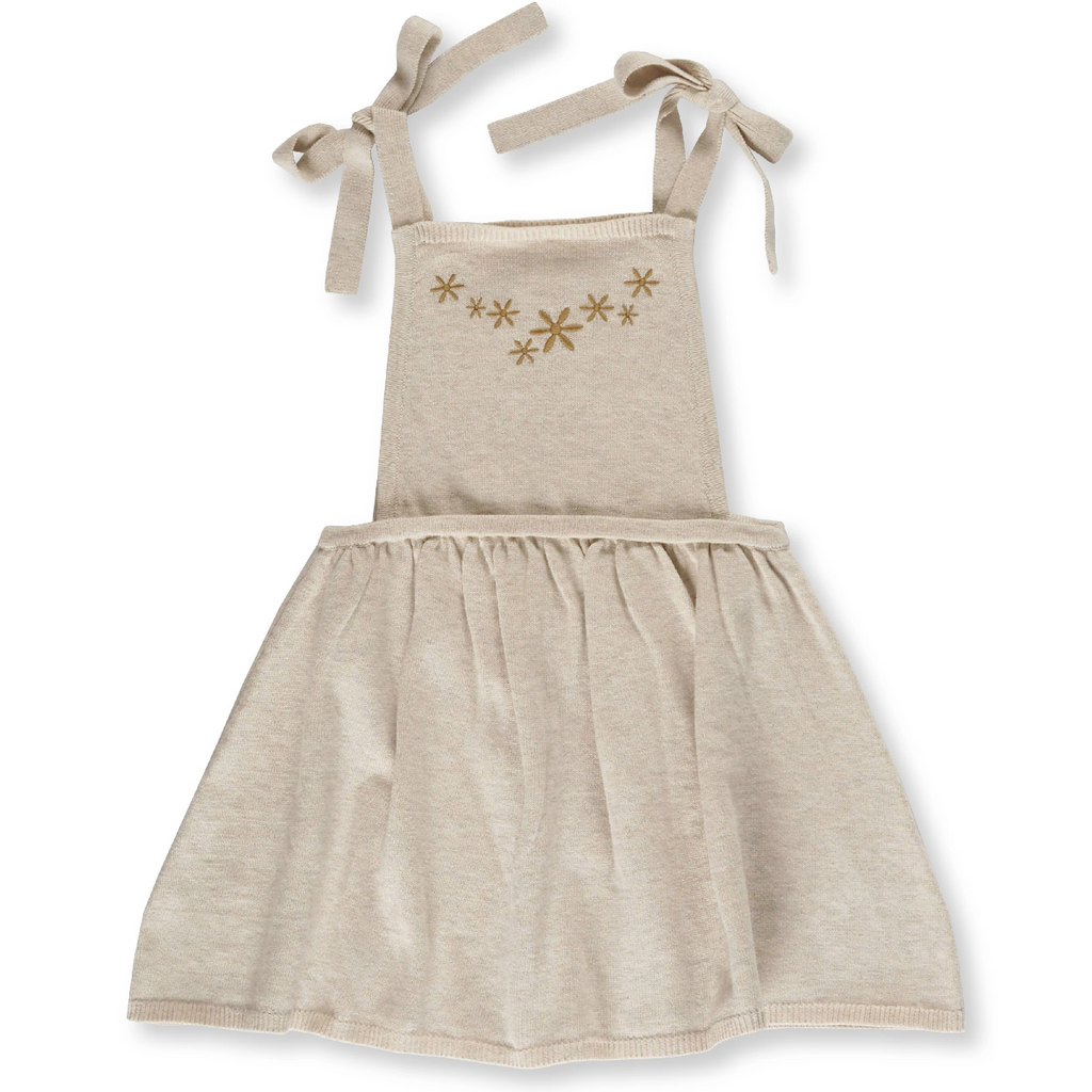 US stockist of Grown Clothing's Flower Field dress made from organic cotton.  Features gathered skirt, ties at shoulder and had machine embroidered gold flowers on the bib.  Oatmeal in color.