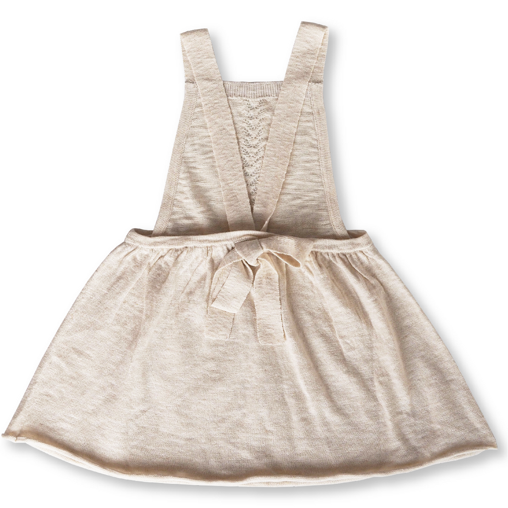 US stockist of Grown Clothing's slub linen dress in oat.  Made from a cotton line blend, with adjustable straps that tie in a bow at the back.  Features a rolled hem and sweet pointelle knit details down the front of the dress.