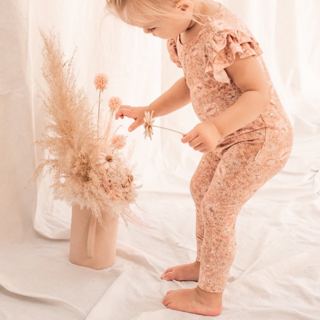 US stockist of India & Grace's short sleeve Fleur Floral Ruffle Romper, made from buttery soft bamboo.  Features double ruffle sleeves and snaps at crotch.