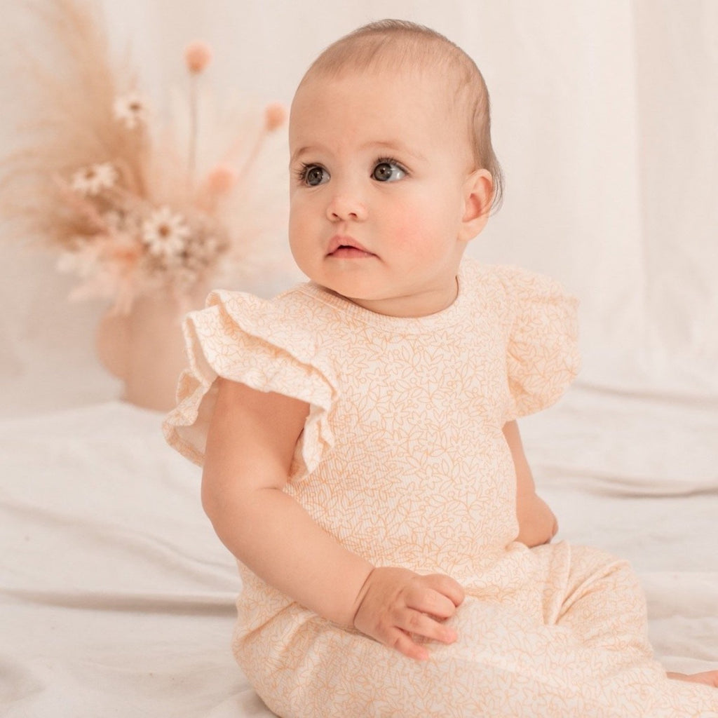 US stockist of India & Grace's short sleeve Honey Floral Ruffle Romper, made from soft ribbed cotton.  Features double ruffle sleeves and snaps at crotch.