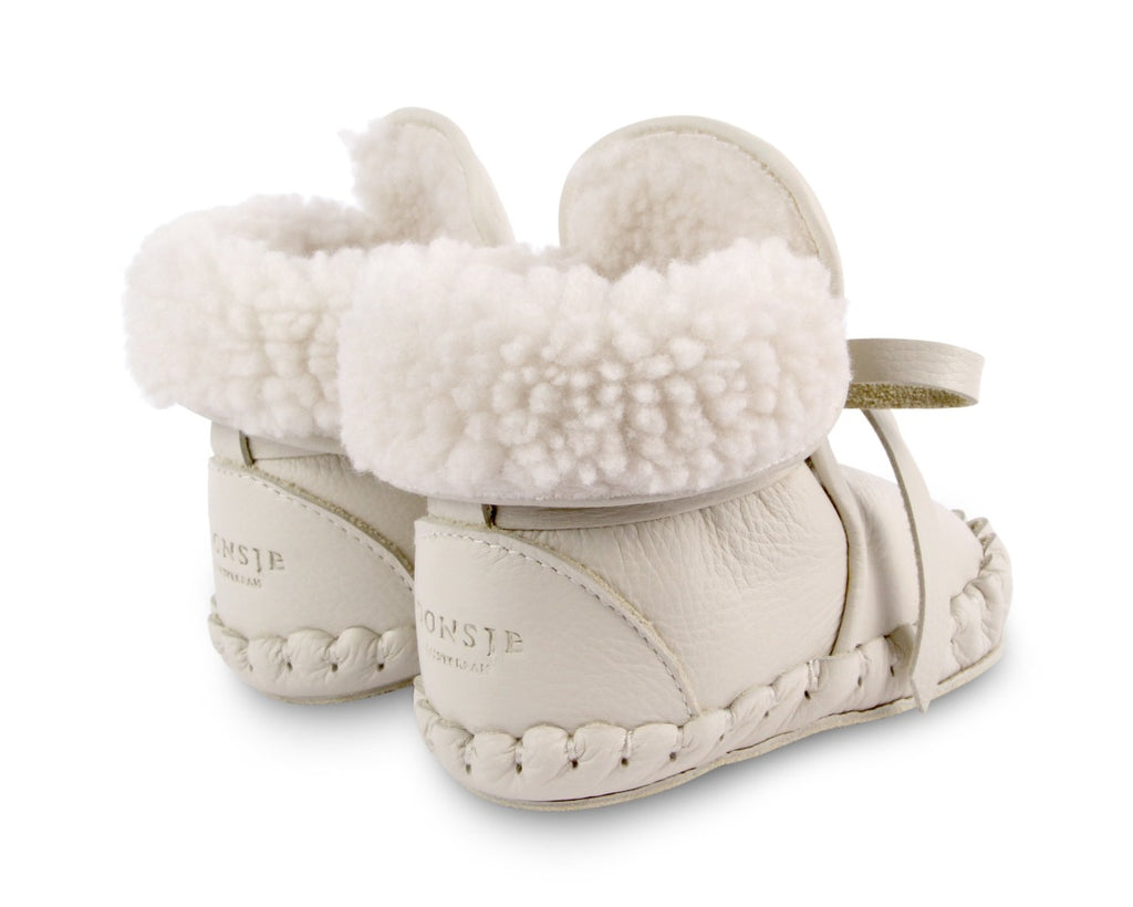 US stockist of Donsje's gender neutral Jaya baby shoe in off white leather.  Handmade, moccassin style shoe, lined and with laces.