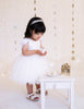 US stockist of Karibou Kids white Angelina Feather and Lace Dress.  Features 5 layer full skirt, lace bodice, scoop back and ostrich feather flutter sleeves. 